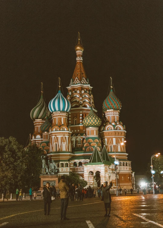 people standing on the road looking at the red square