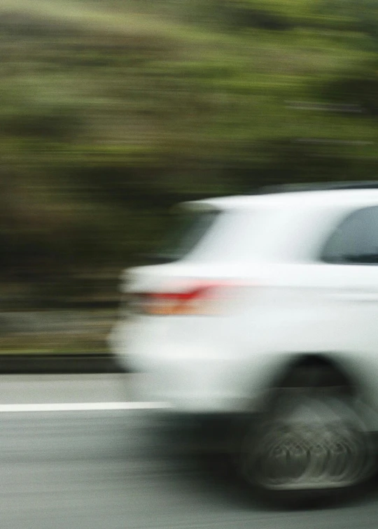 blurry pograph of a car on the road