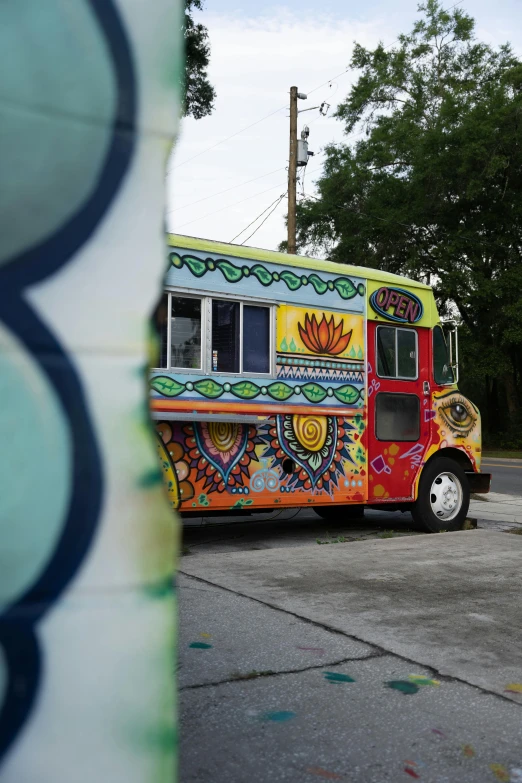 a colorful food truck is parked in a parking lot