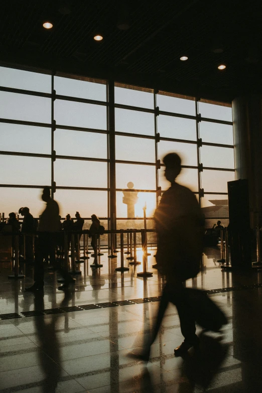 a number of people near a very large window