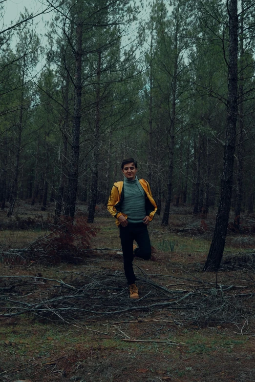 a man is walking through the woods in the rain