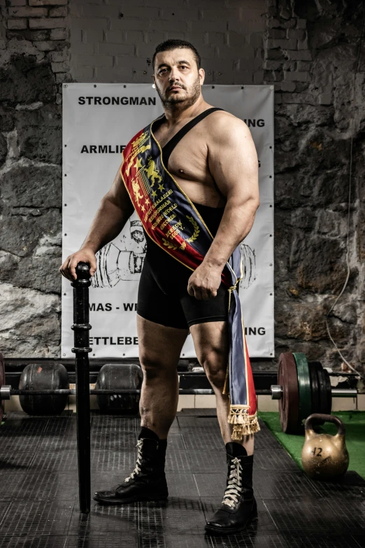 a man with a pro wrestler belt holding his stick