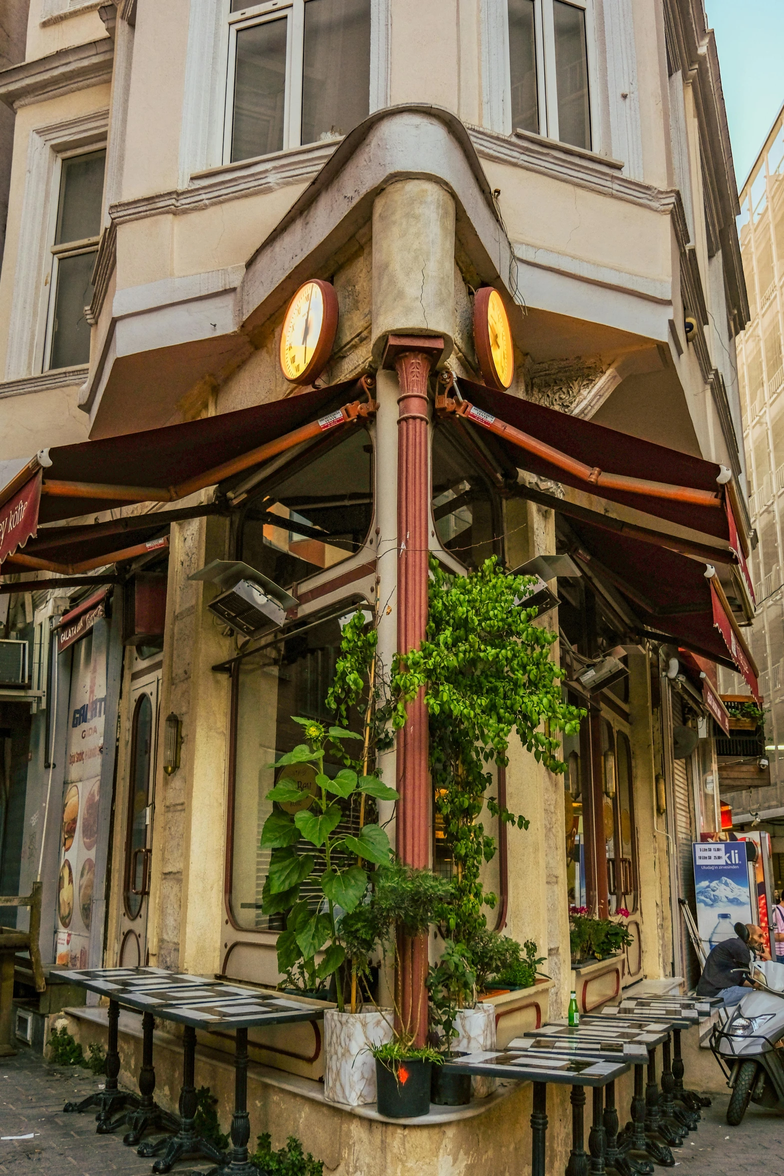 outdoor restaurant, displaying a few potted plants