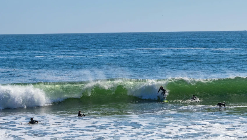 three surfers are riding a wave together in the ocean