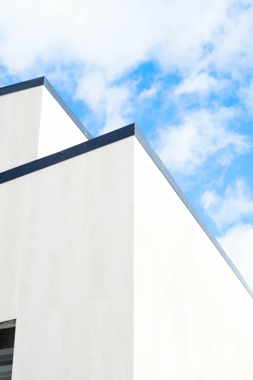 a building is against the blue sky with clouds