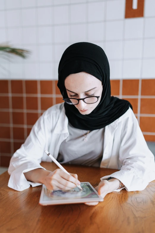 a woman is using a tablet on the table