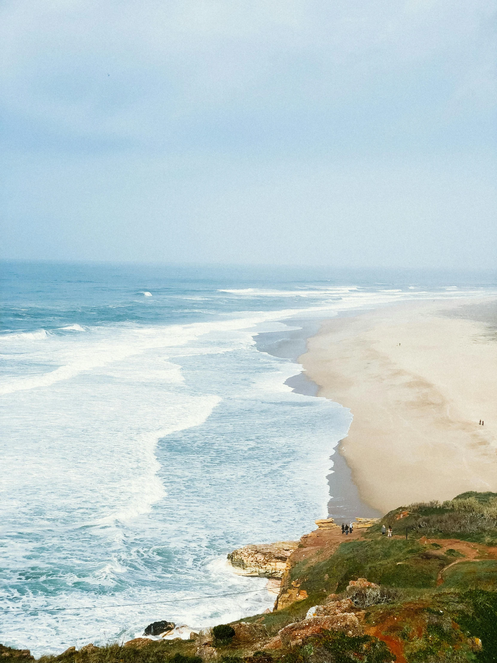 the beach is near the shore by the ocean