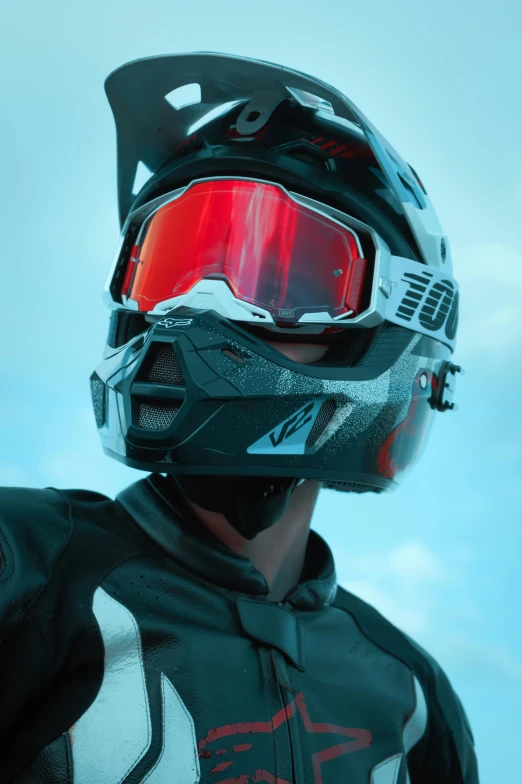 a man in black suit and red goggles wearing a helmet