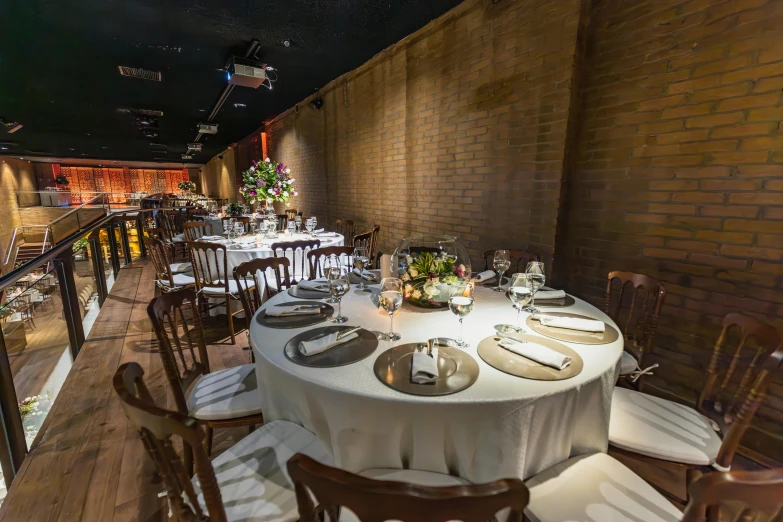 a very large banquet set up with white clothed tables