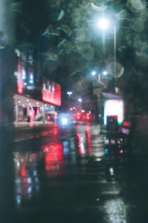 a street scene with focus on a wet pavement