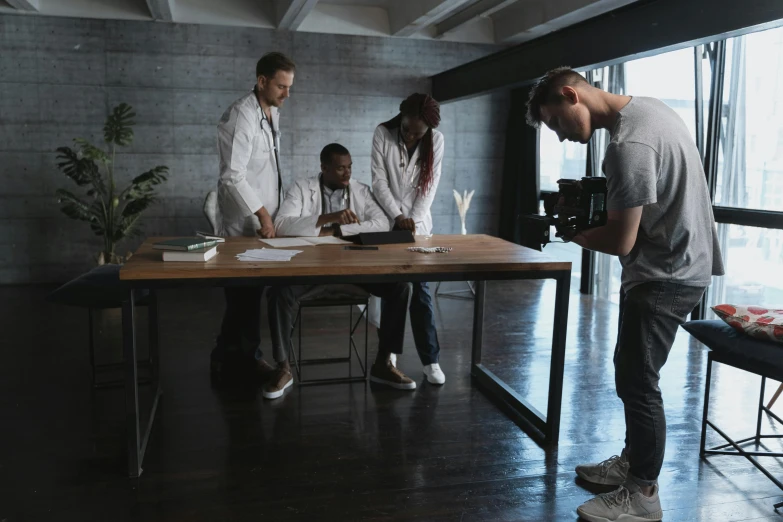 a group of people sitting around a table looking at a picture on it