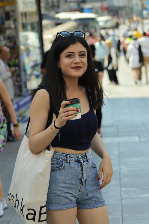 a woman walks down the street with her cell phone