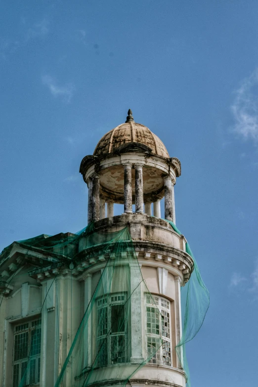 an old and dusty looking building with netting on it