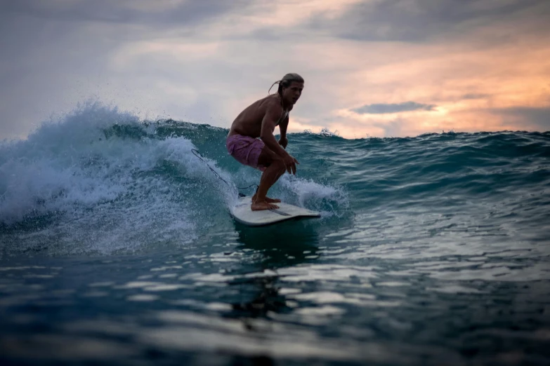 the surfer has jumped into the air with his surfboard