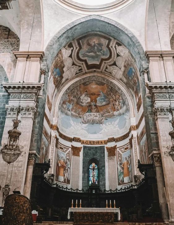 the interior of a church with large stained glass windows