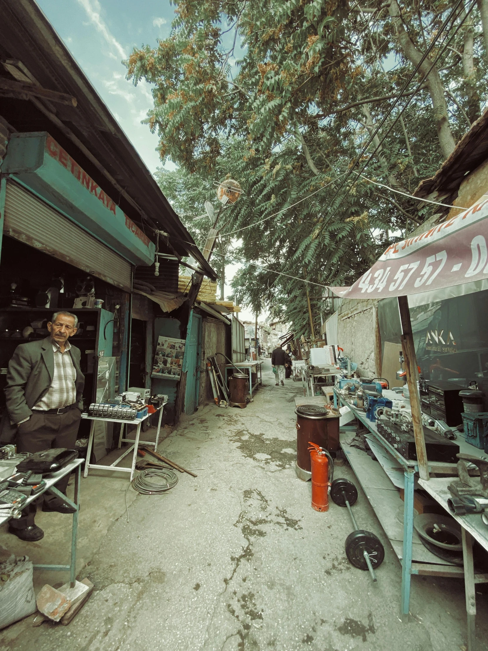 an alley with people outside walking by