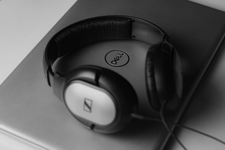 closeup of black and white headphones on top of a notebook