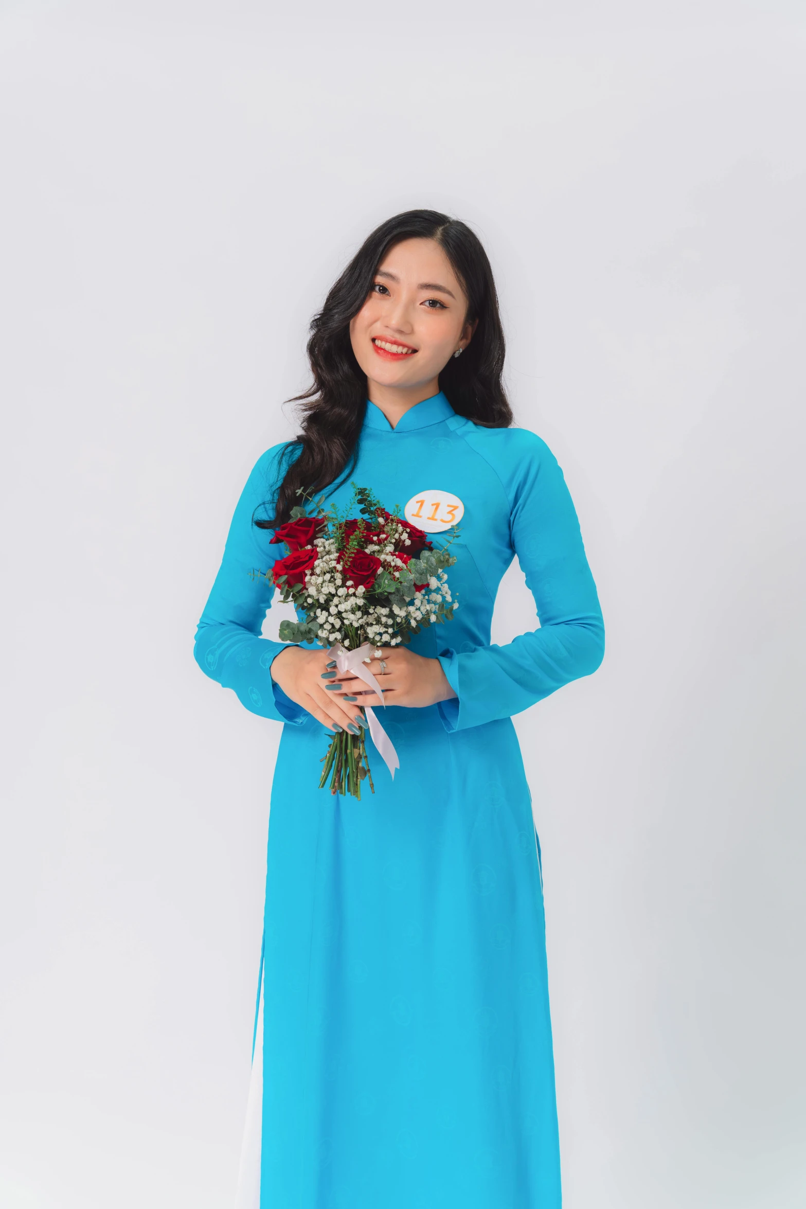 a woman in blue with flowers standing on the side