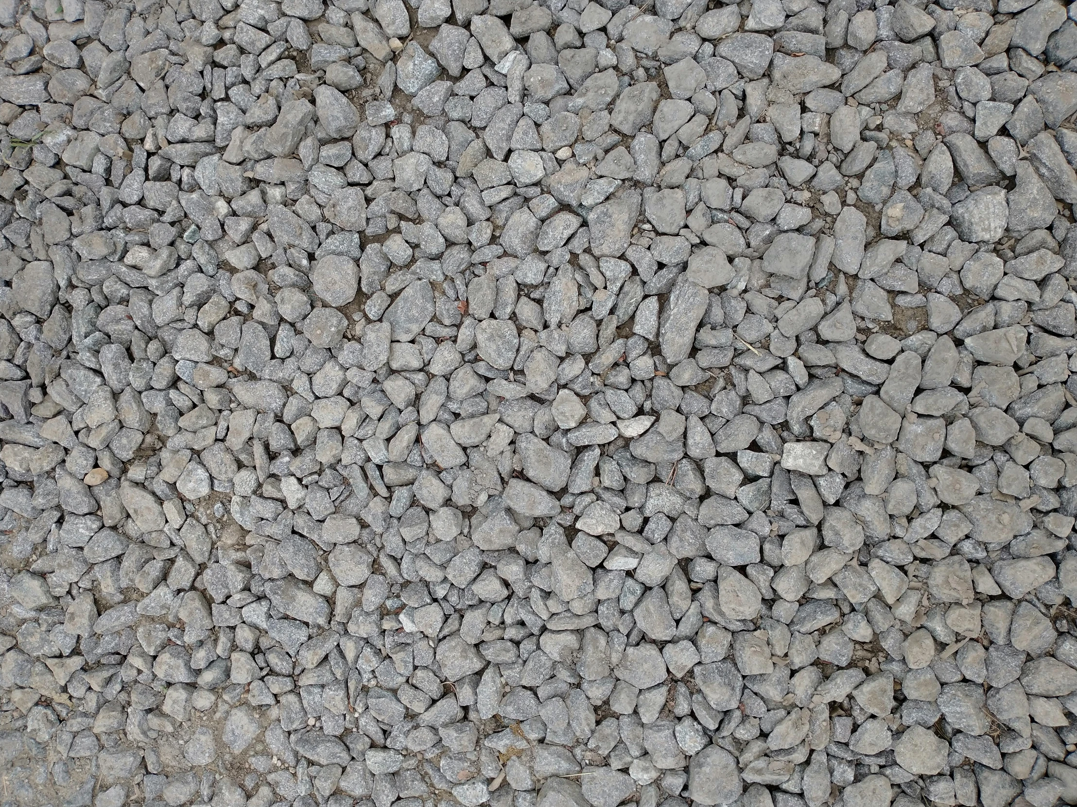 a large rock filled field with gravel as the backdrop