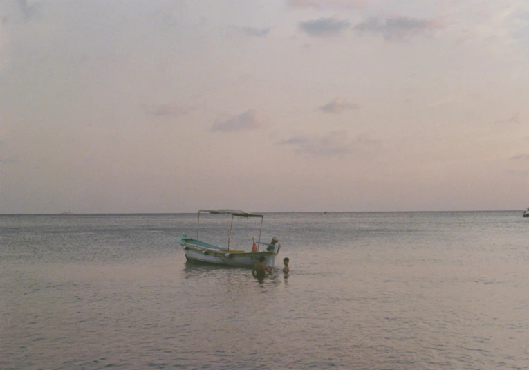 a boat sits in the water at low tide