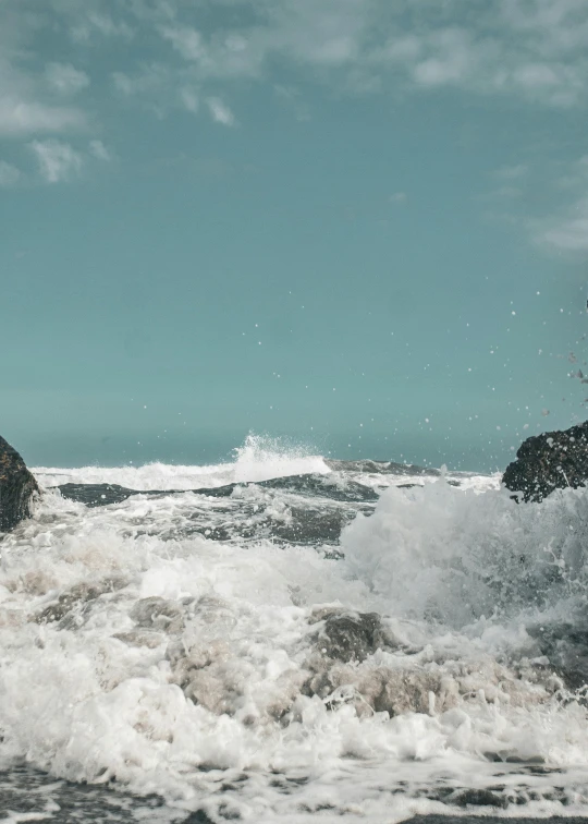 there are two large rocks out on the water