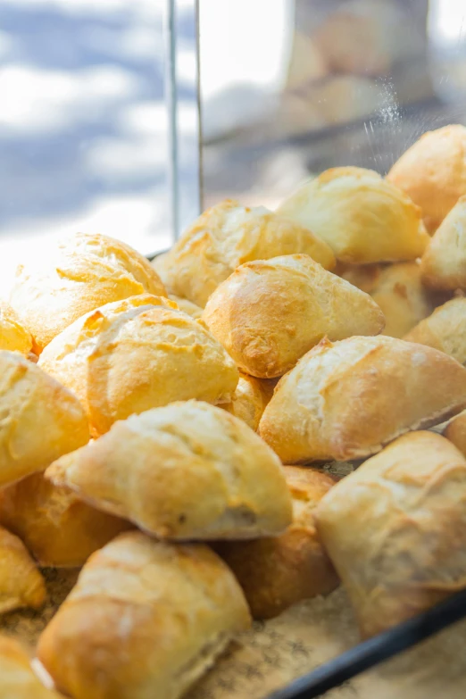 bread rolls and pastries on display in a bakery