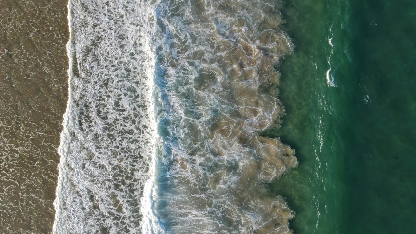 an aerial s of a water line and the ocean