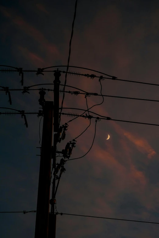 the view from behind power lines and power lines at dusk