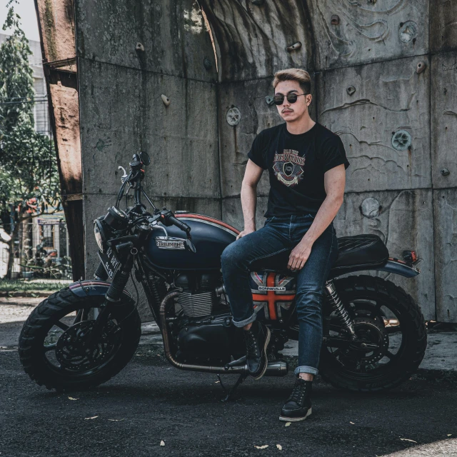 the man is posing for his picture sitting on a motorcycle