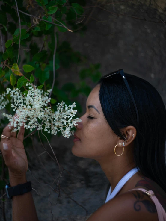 a woman smelling flowers with her eyes closed