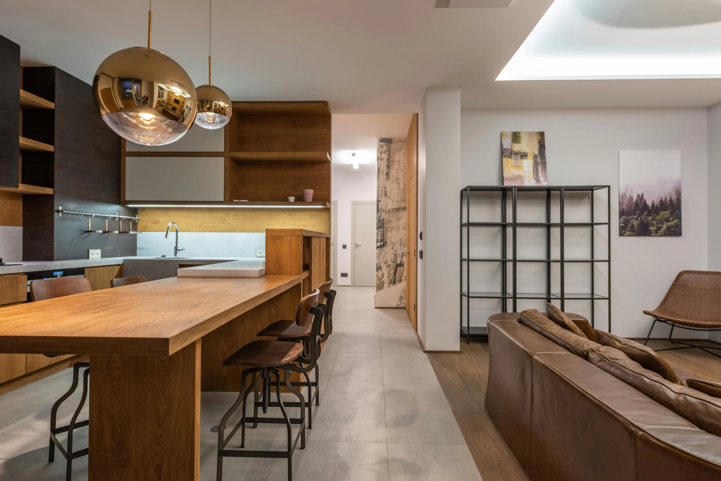 a kitchen area with chairs and a couch next to the kitchen