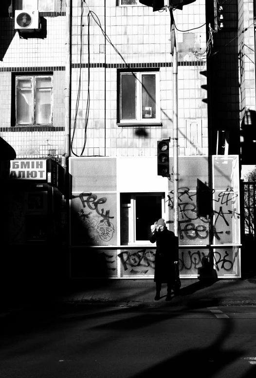 a man is talking on a phone at a cross walk