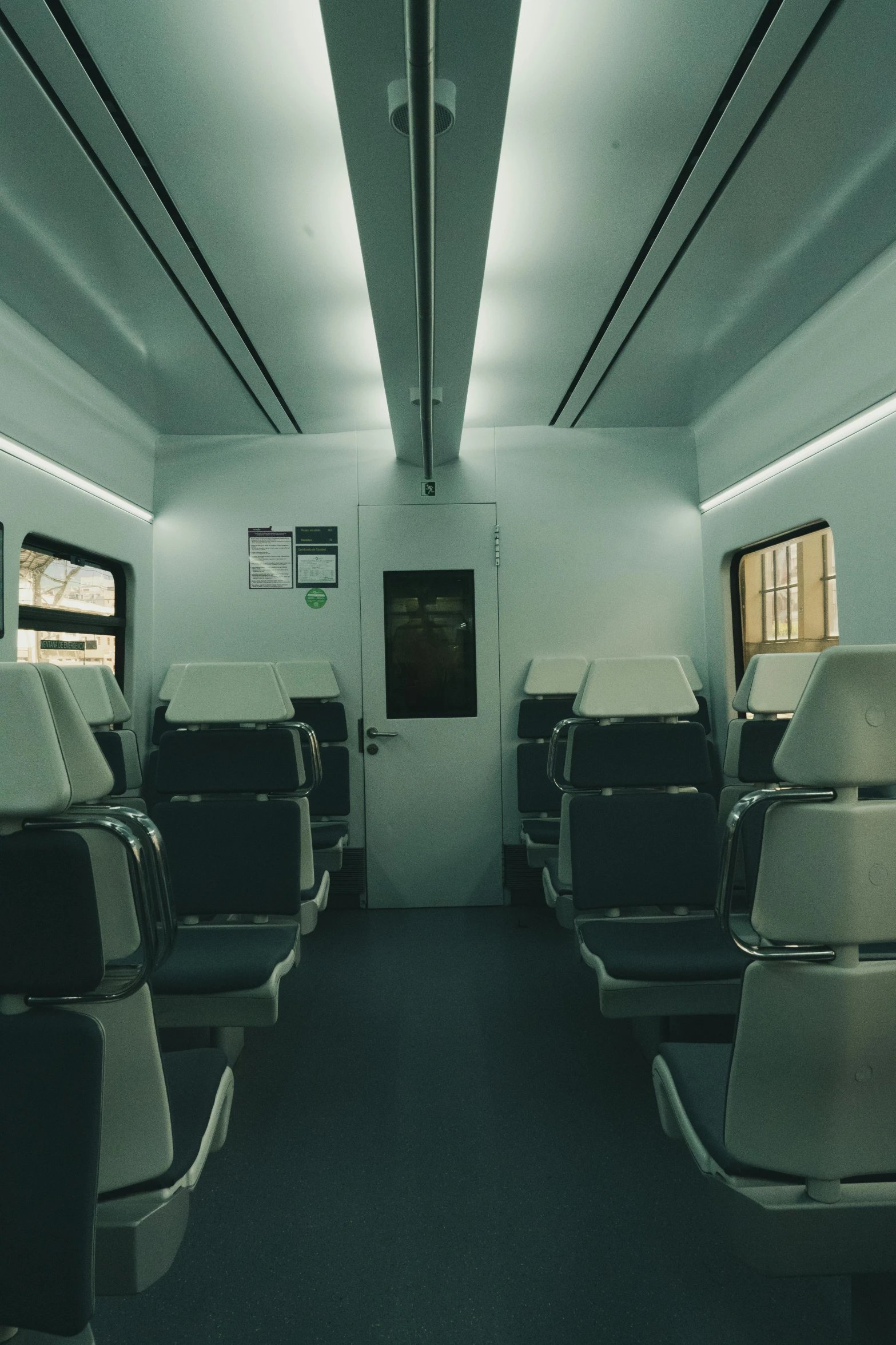 empty passenger train car with three windows and lights