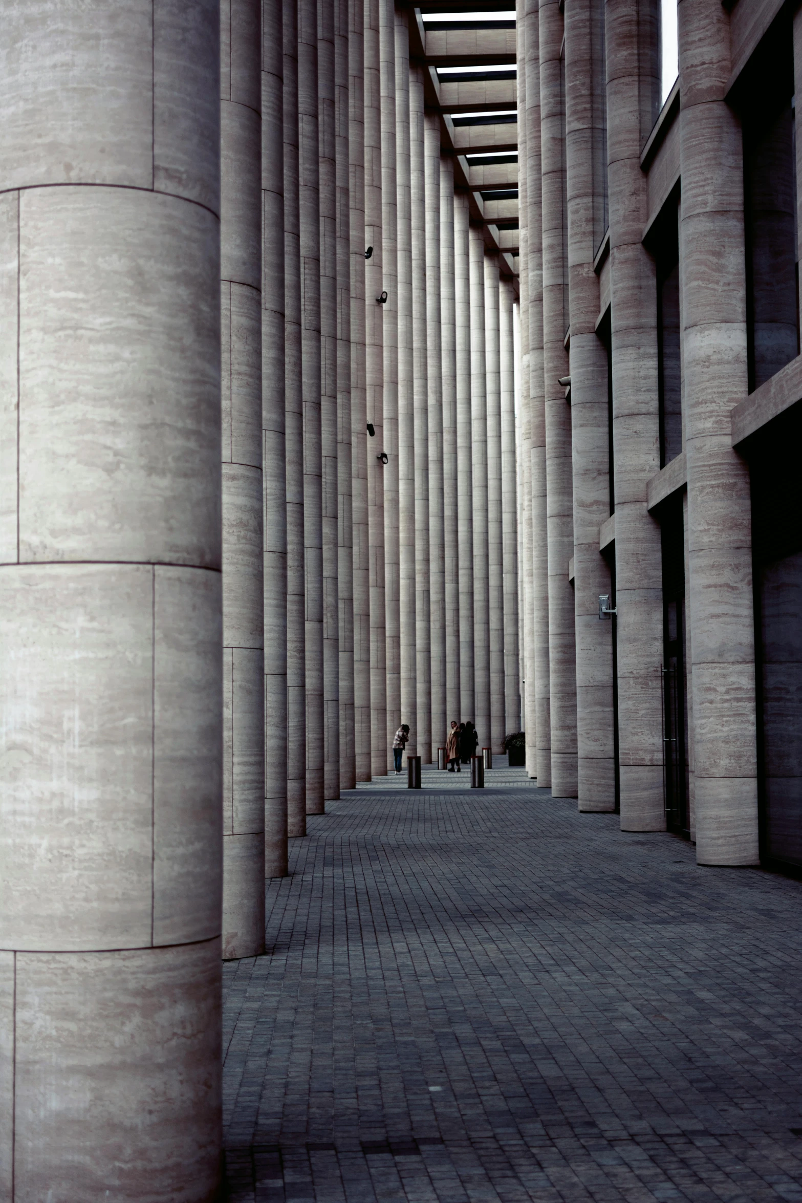 the columns are lined with benches and some people