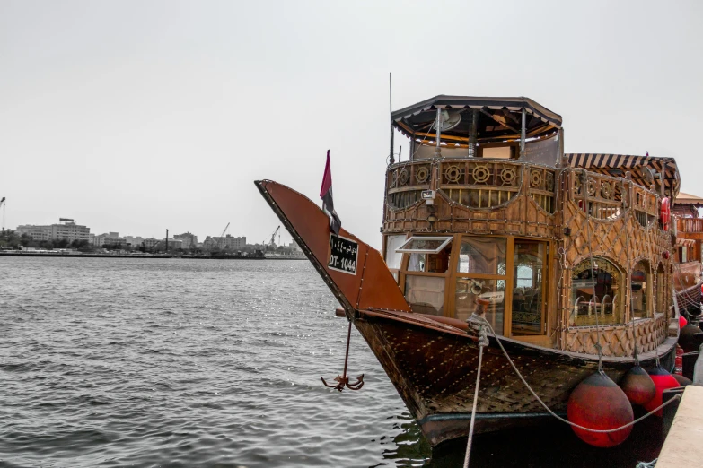 a boat with a tower on top of it sitting in the water