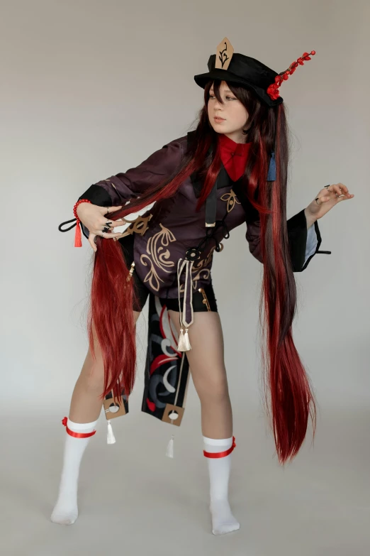a doll in long red hair is standing with hands together