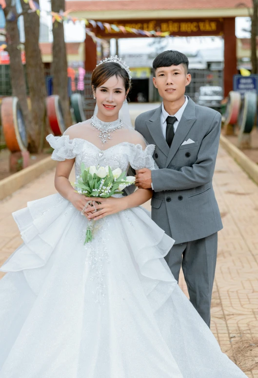 a bride and groom on the street posing for the camera