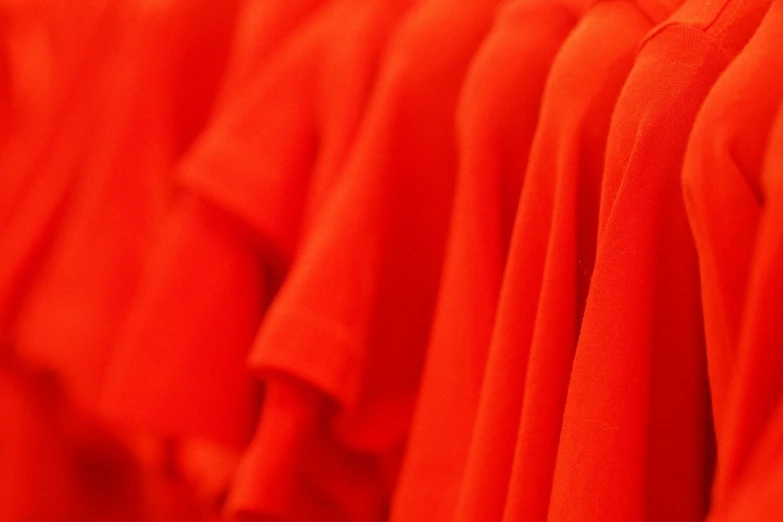 a red dress hangs on display in a store