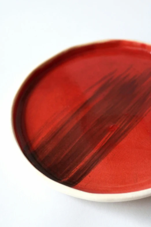 a red and black plate with one brown plate