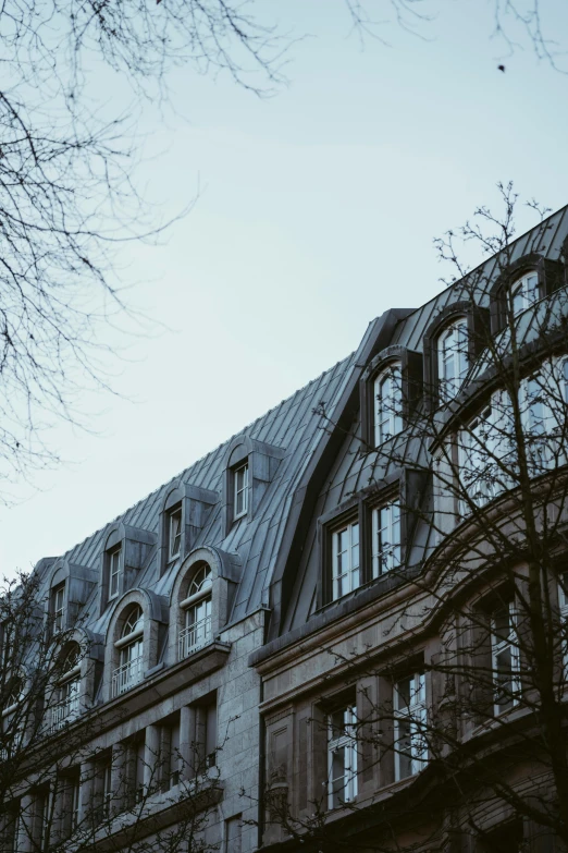 the front of a large building with some trees