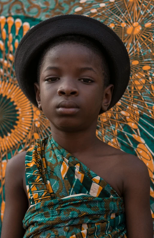 a child with an interesting outfit in front of an umbrella