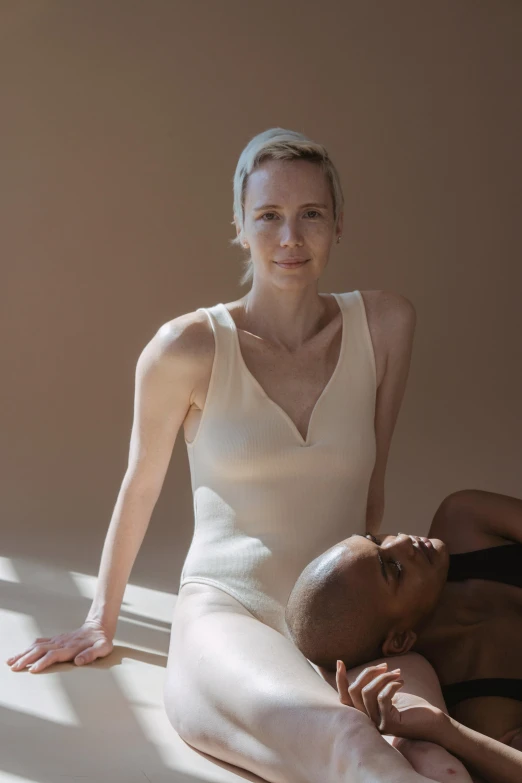 a beautiful woman sitting next to another young man