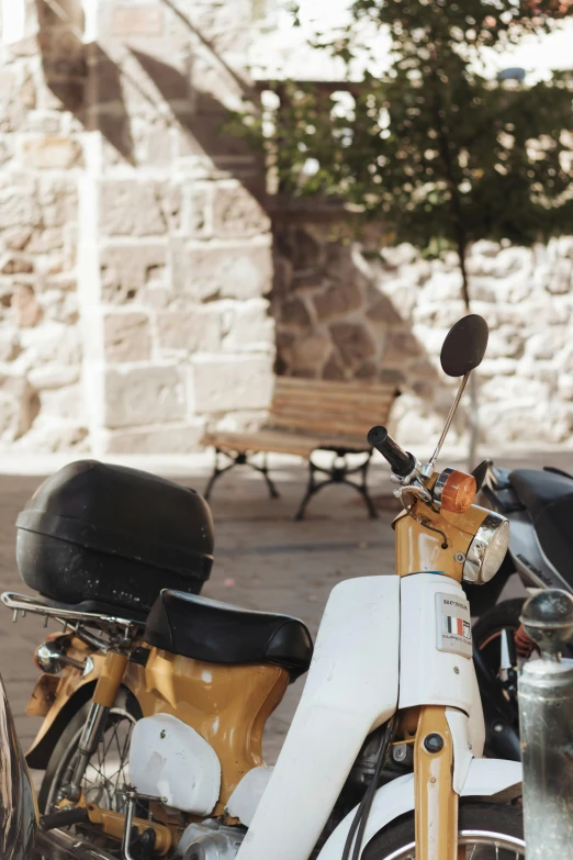 an old motor scooter and a small chair in front of a building