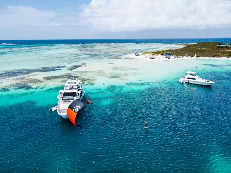 some boats and a island in the middle of water