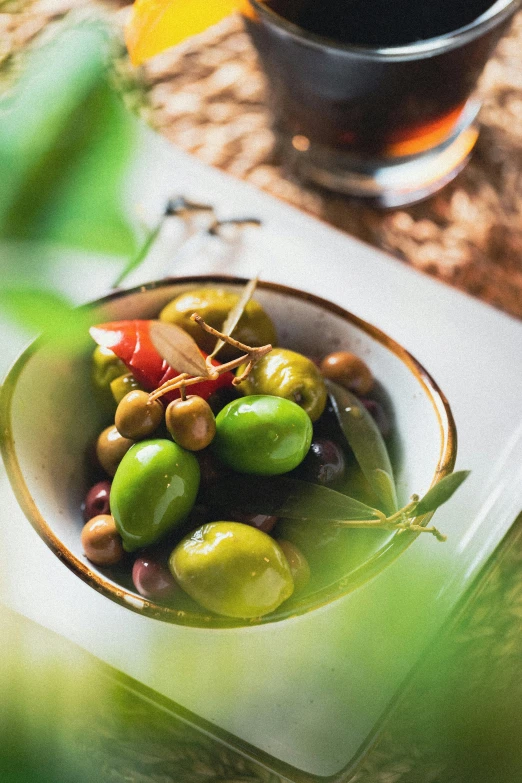 a bowl full of olives and red peppers