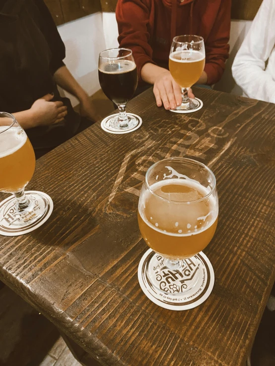 people sitting at a table with a large glass of beer