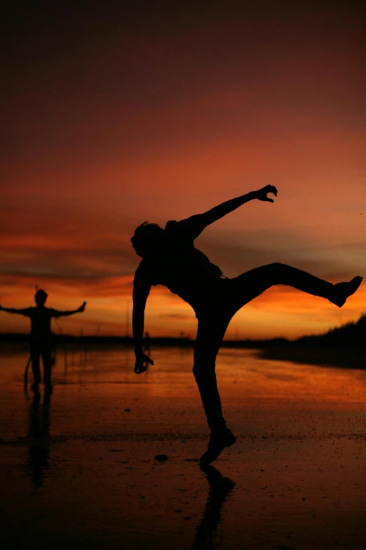 a person is doing a kickflip in front of a sunset