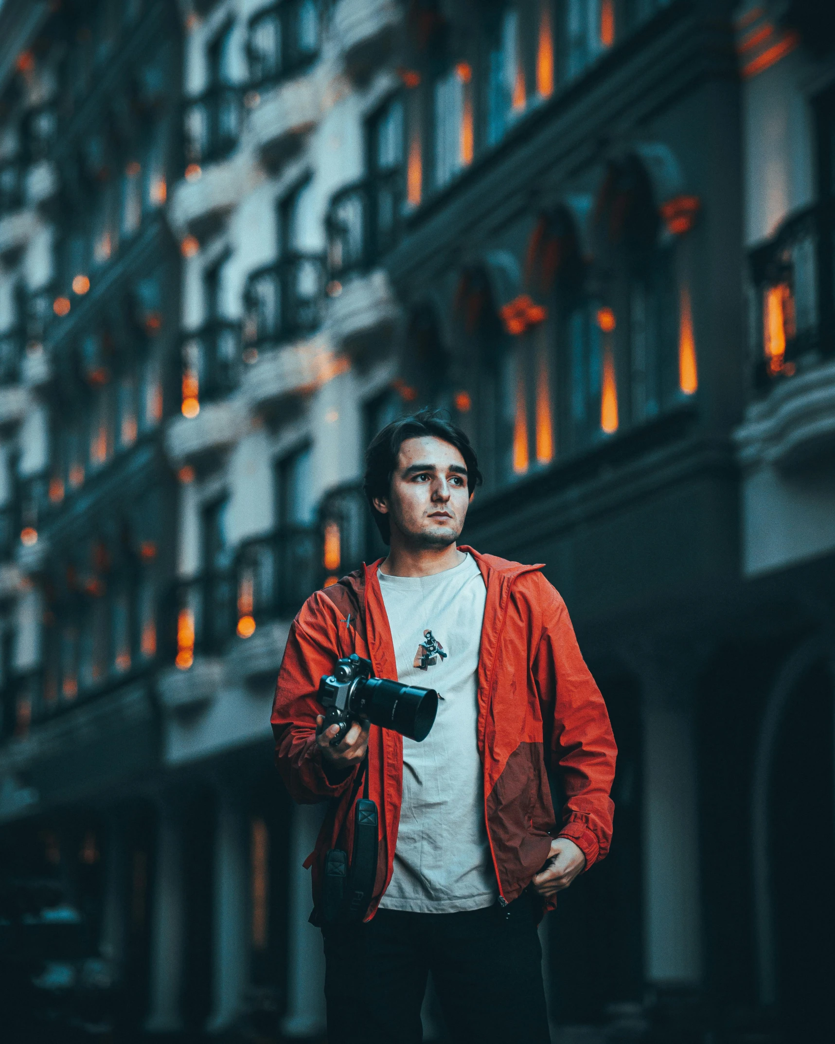 a man taking a po near a tall building with his camera