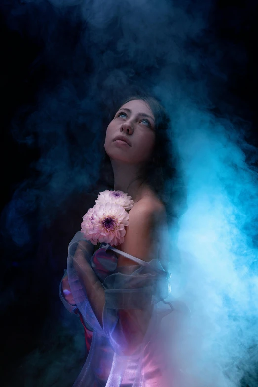 a woman posing while holding a piece of clothing