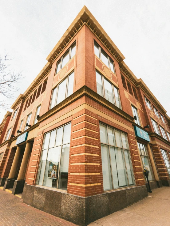 a red brick building with windows is in front of it